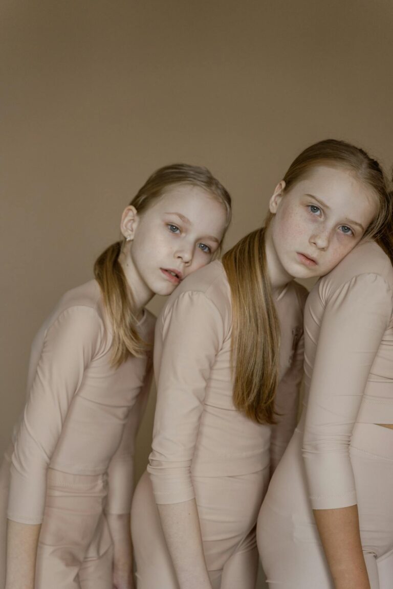 Graceful young dancers pose in coordinated beige outfits, exuding elegance and harmony.